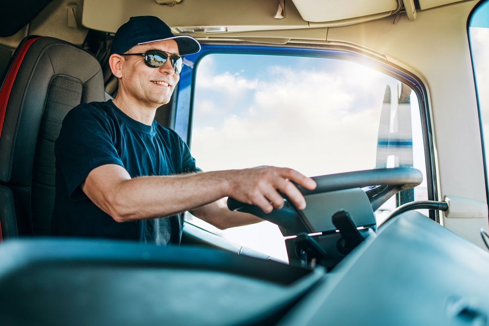 Image of a semi truck driver in the cab of a truck driving for Fastrack Solutions a CDL staffing agency in Ventura