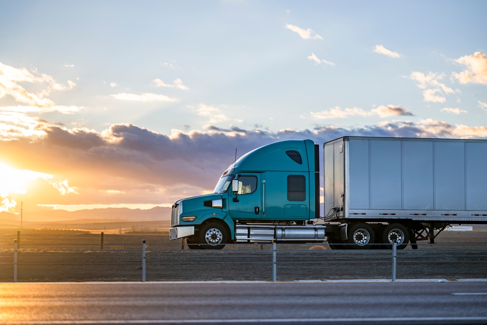 image of semi truck driving at sunset from a cdl driver staffing agency in san bernardino hire