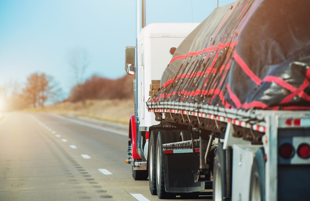 image of a loaded CDL truck being driven down the freeway from cdl driver staffing in stockton