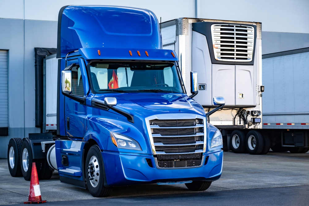 image of a blue semi truck parked in a lot awaiting a driver hired by a cdl driver staffing agency in long beach california